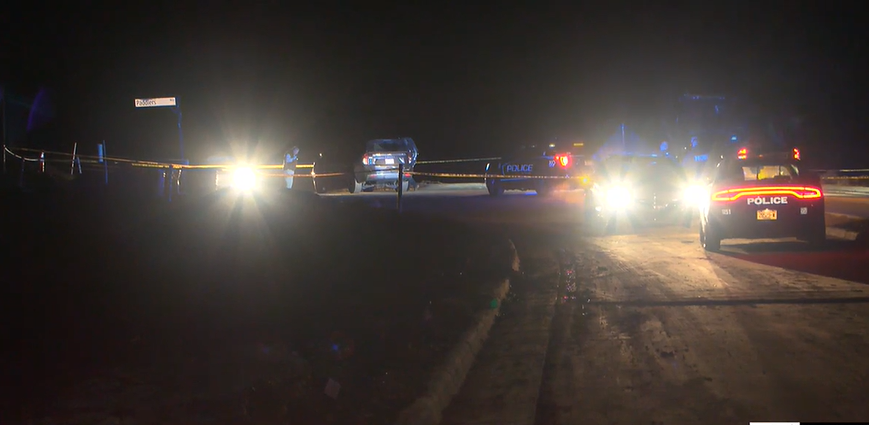 Police tape and police vehicles.